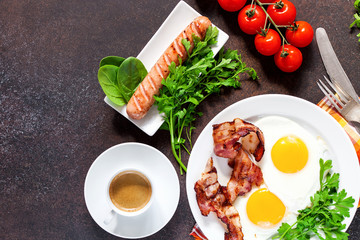 Flat lay of concept breakfast with setting food products over darken background. Top view. Copy space