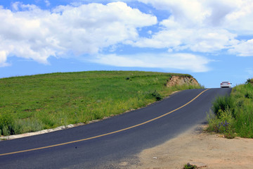 asphalt road on grassland