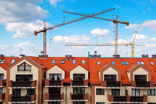 New Family Apartment Building, And Construction Cranes Build New Houses. Expanding City View. Wroclaw, Poland, Europe