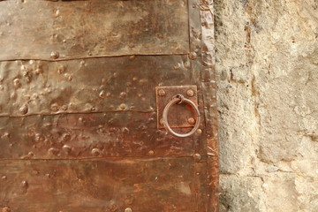 ancient metal gate of the fortress with a window