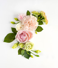 Flowers composition with place for text. Frame made of fresh flowers. Flat lay, top view