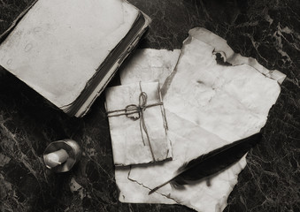 aged retro papers and book on table with detective tools background