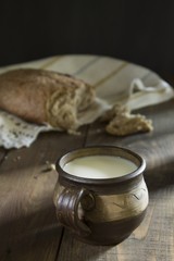 FRESH MILK WITH BREAD ON TABLE