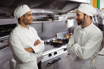 Chefs interacting with each other in kitchen