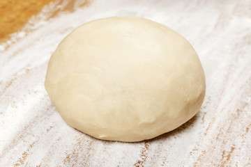 Fototapeta na wymiar Raw dough on wooden board
