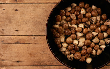 Fried potatoes and mushrooms in frying pan