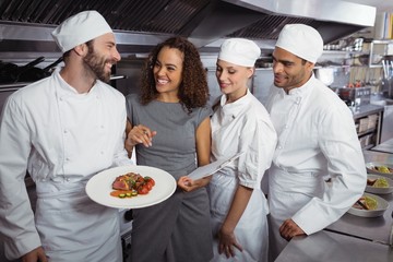 Restaurant manager interacting with his kitchen staff