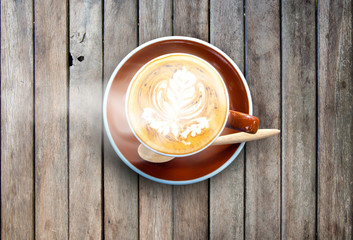 Cup of coffee and smoke on wooden desk table background.