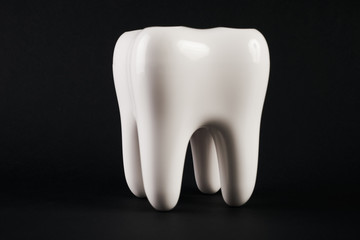 White healthy Tooth isolated on black background