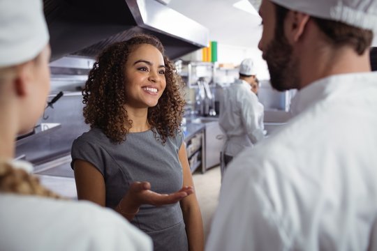 Restaurant manager interacting with his kitchen staff