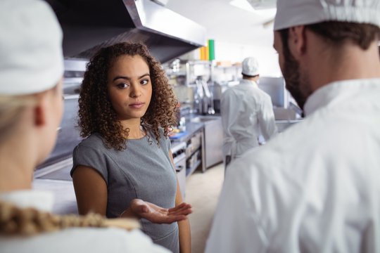Restaurant manager interacting with his kitchen staff
