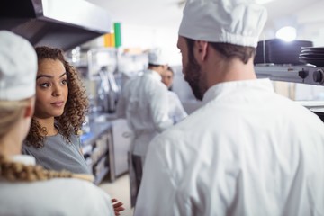 Restaurant manager interacting with his kitchen staff