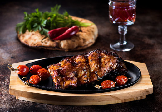 Grilled pork BBQ ribs and glass red wine