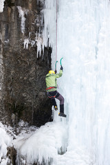 The climber climbs on ice.