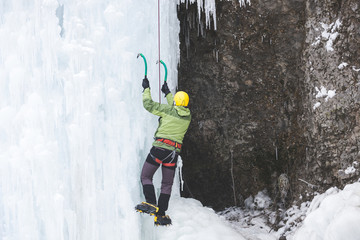 The climber climbs on ice.