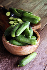 Fresh and sliced cucumbers. Sliced cucumbers on a cutting board.