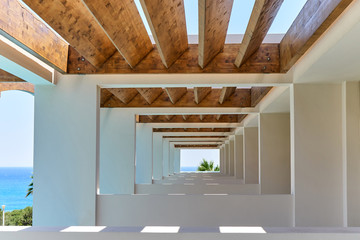 Contemporary corridor of tropical resort terrace under wooden beams