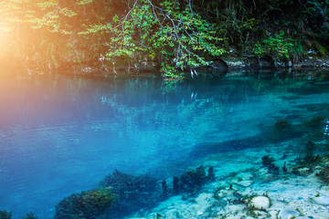 Amazing view of blue mountain lake like paradise, rock wall and colorful water .Scenery of Abkhazia paradise nature with awesome closeup perspective and fast stream.