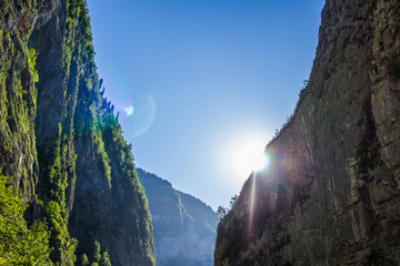 The sun shines through the gorge in the mountains
