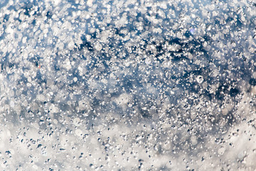 Abstract background of drops of water on the fly