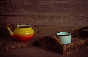 Metal dish on a wooden burned rustic texture for background. Rough weathered wooden board. Toned