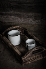 Metal dish on a wooden burned rustic texture for background. Rough weathered wooden board. Toned