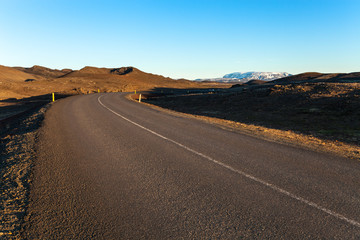 Asphalt road on the shore of the fjord in the east of Iceland