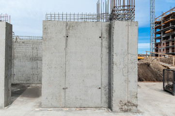 Concrete wall for a building under construction with reinforcement net of concrete in the construction site, metal rods for strength