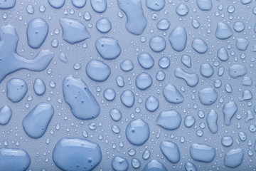 Drops of water on a color background. Gray