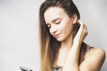 Fototapeta premium Beautiful young woman with mobile phone texting,looking something