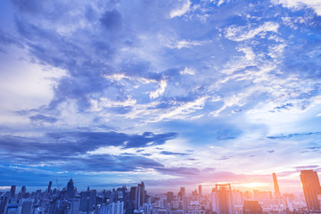 beautiful brilliant and dynamic clouds over city at sunset, long exposure photography for cloud movement