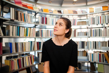 Young student girl in a library