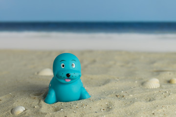 Fototapeta na wymiar A toy seal on the beach