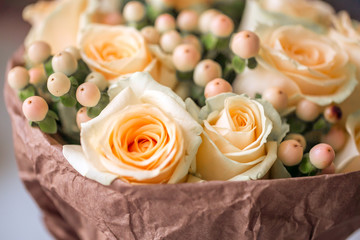 Bouquet of beige roses with hypericum