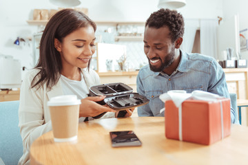 Gorgeous woman looking inside VR headset with her friend