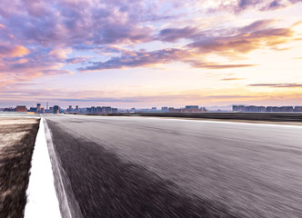 Fototapeta premium empty asphalt road with cityscape of modern city