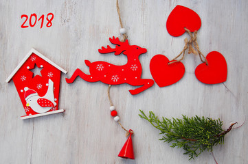 Wooden christmas decoration over wooden background- christmas house, star, tree and deer
