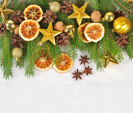Dried oranges and cones, Christmas decorations and spruse branch on a white