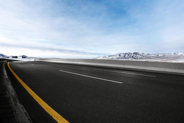 empty asphalt road with beautiful snow mountains