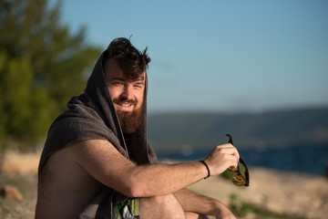 young man with beard smiling ,enjoying the sun 