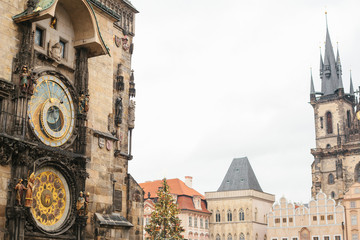 Old Town Square in Prague on Christmas Day. View of an astronomical clock, a Christmas tree and a castle. Christmas in Prague. Celebration of holidays in Europe.