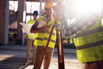 Portrait of construction engineers working on building site