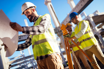 Portrait of construction engineers working on building site