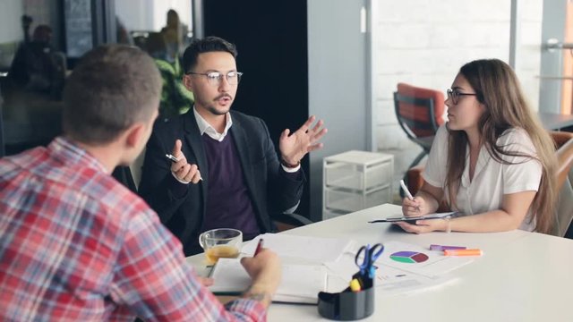 Group of business people working together, meeting and brainstorming in office.