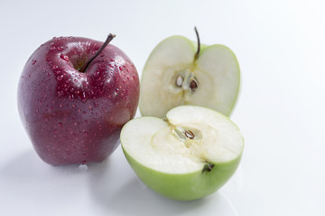 red and green apple on white background.