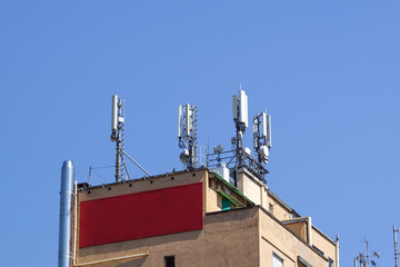 GSM transmitters on a roof of white administrative building. Close up