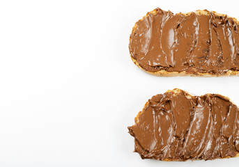 Chocolate spread on bread on white background. Isolated. Copy space.