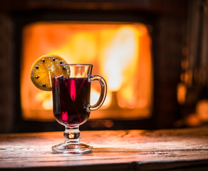 Hot mulled wine with orange slice, cloves and cinnamon stick.