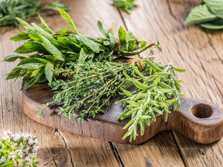 Fresh herbs on the wooden table.