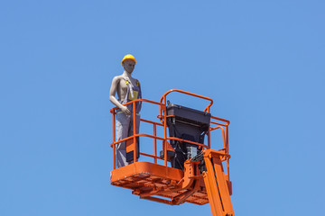 Hydraulic mobile construction platform elevated towards a blue sky with false construction workers...